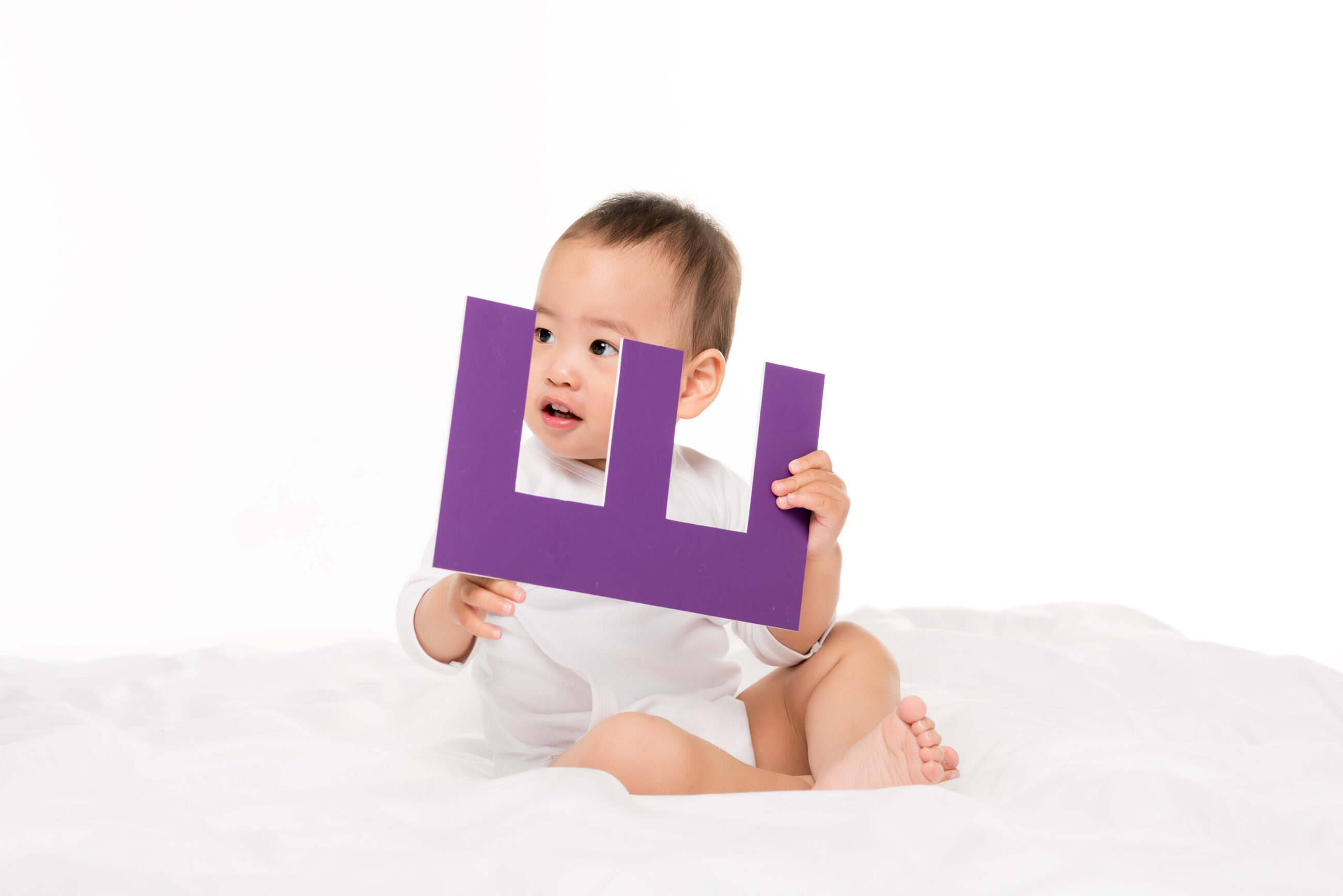 baby holding letter e